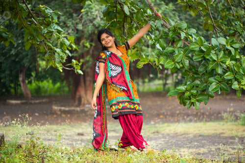 Preview: Beautiful girl between nature full of branches of tree.