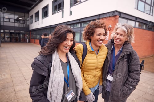 Preview: Group Of Smiling Female Mature Students Walking Outside College Building