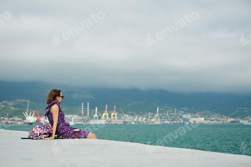 Preview: Woman enjoying seascape on waterfront
