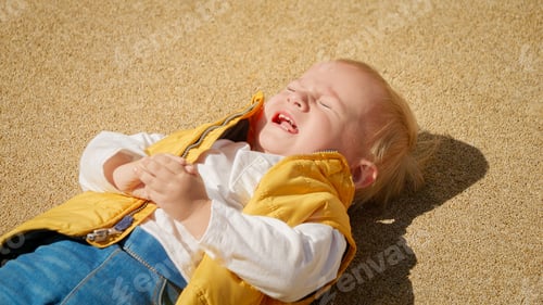 Preview: Little baby boy getting very upset lying on the ground and crying. Upset children, negative emotions