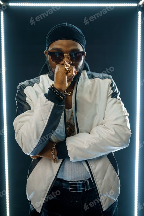 Preview: Stylish rapper in sunglasses, dark background