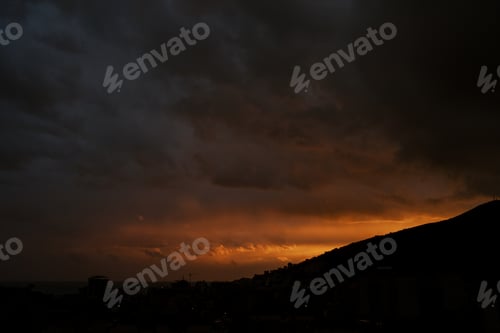 Preview: Orange reflections of a sunset over a mountain range