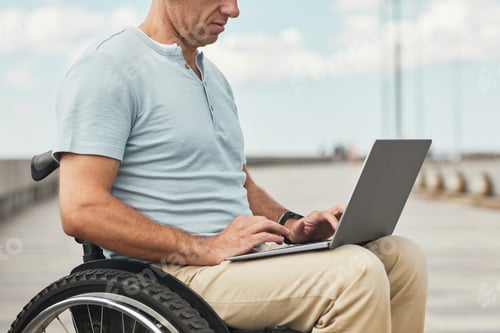 Preview: Man in Wheelchair using Laptop