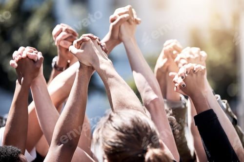 Preview: Uniting for a cause. Shot of a group of protestors with their fists raised.