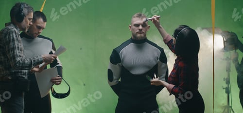 Preview: Medium Shot Of A Cosmetician Preparing An Actor While Others Discussing Over The Script Before