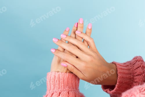 Preview: womans hands with bright pink nail color