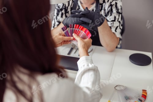 Preview: Nail master doing nail care for client in work studio