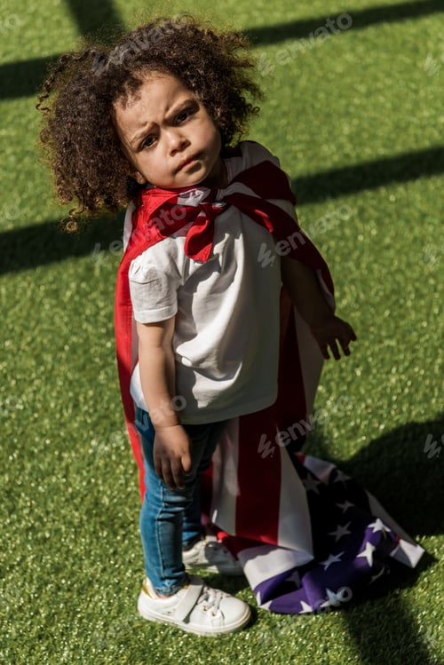 Preview: Small african american girl with american flag like superhero cape