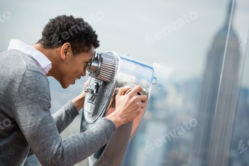 Preview: An observation deck overlooking the Empire State Building. A man looking through a telescope.