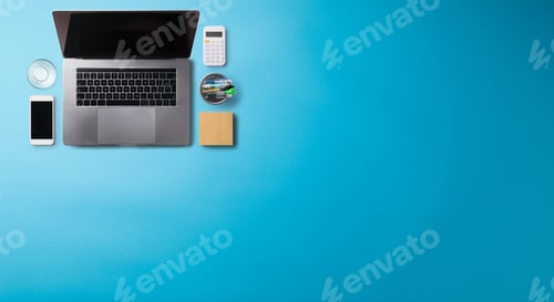 Preview: Flat lay top view office desk working space with laptop on blue background. Copy space