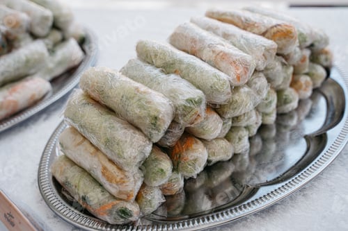 Preview: Stacks of fresh spring rolls on a platter.