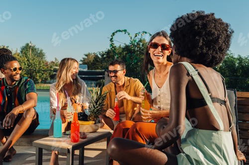 Preview: Friends enjoying drinks and fruit by the pool on a sunny day