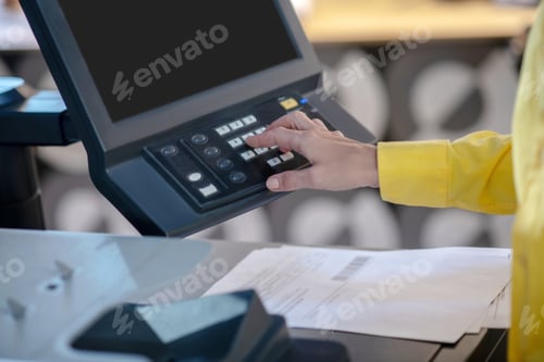 Preview: Female hands adjusting setting on printing machine