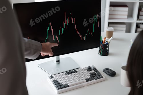 Preview: Close up view of young business team analyzing the stock market trend, focusing on computer monitor.