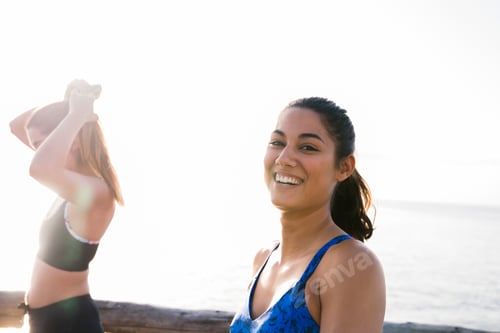 Preview: Portrait of two young women training on beach