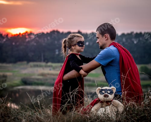 Preview: little girl with dad dressed in super heroes, happy loving family
