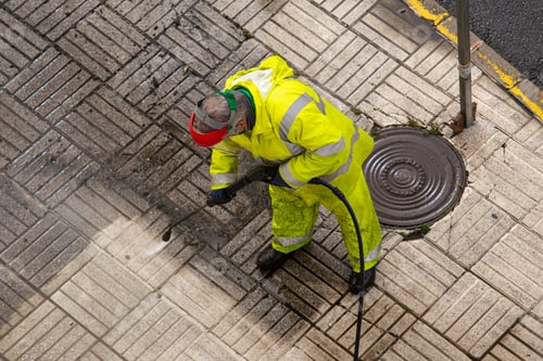 Preview: Worker cleaning a street sidewalk