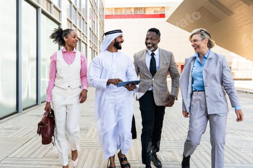 Preview: Group of multiethnic business people meeting an emirati businessman