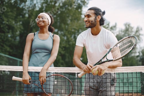 Preview: Two tennis players talking on a tennis court before the match