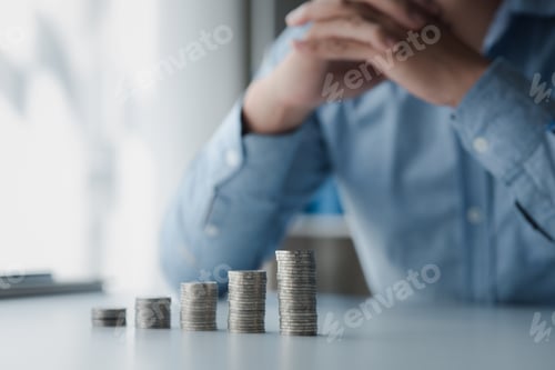 Preview: A businessman is keeping a record of his income and expenses.