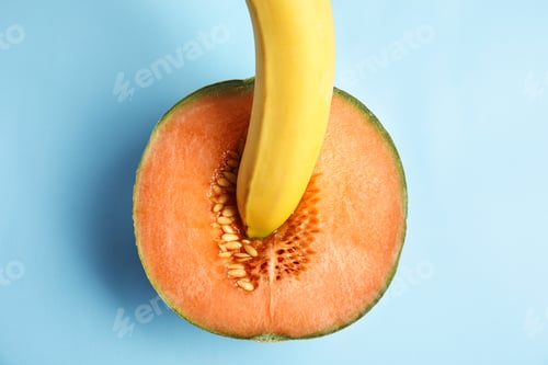 Preview: Flat lay composition with fresh banana and melon on blue background. Sex concept