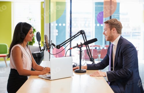 Preview: Young woman interviewing a guest in a studio for a podcast