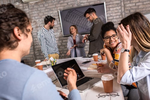 Preview: Group of modern business people discussing architectural designs in the creative office.