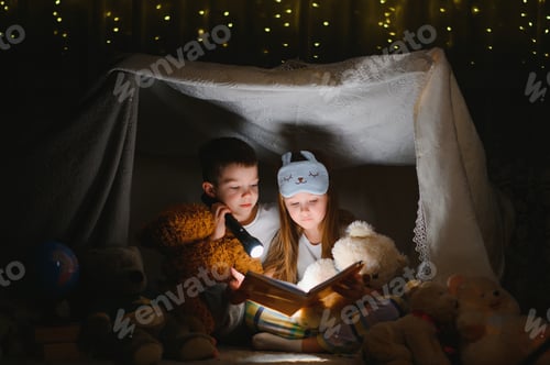 Preview: Little children reading bedtime story at home.
