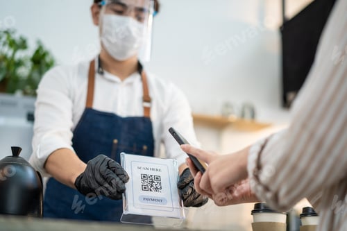 Preview: Close up of woman customer's hand easy contactless payment in cafe during Covid19 Pandemic.