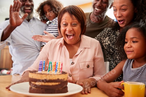 Preview: Multi-Generation Family Celebrating Grandmothers Birthday At Home With Cake And Candles