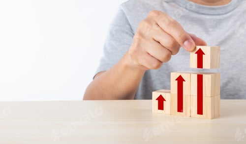 Preview: Hand arranging wood block stacking as step stair with arrow up.