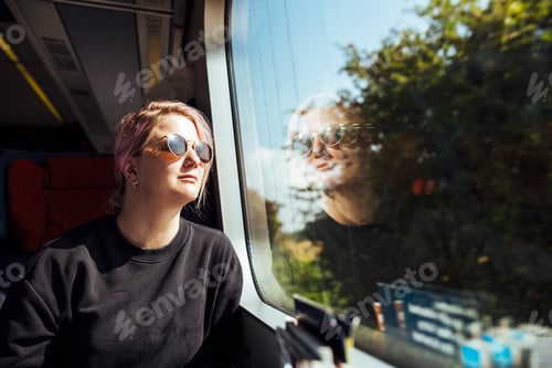 Preview: Woman looking through train window