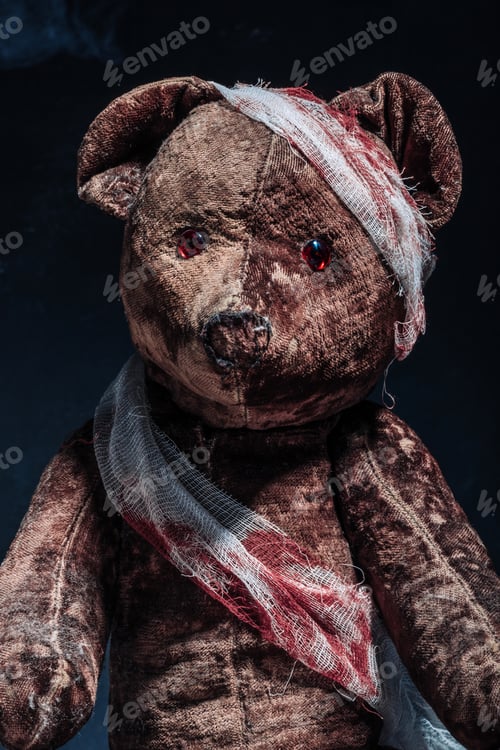 Preview: Old brown teddy bear wrapped in bloody bandages on a black background