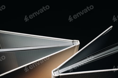 Preview: Composition of photo books in natural white leather of different sizes. The white paper on a dark