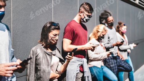 Preview: Side view of people using mobile phone covered by face mask