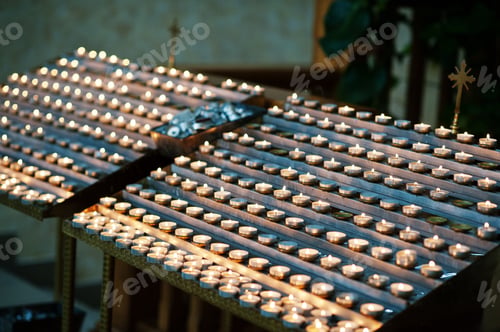 Preview: Candles in church. Rows of burning candles in a cathedral