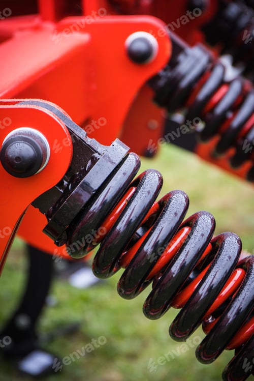 Preview: Black hard spring made of steel. Part of big industrial or agricultural machine