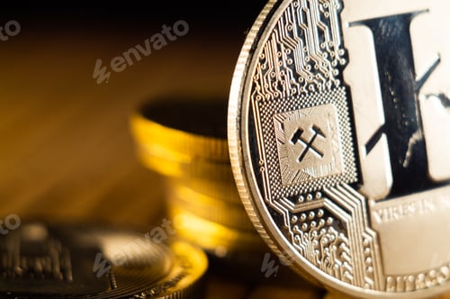 Preview: Closeup shot of gold and silver bitcoins scattered on a surface illuminated with bright light