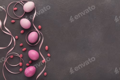 Preview: Easter background. Colored eggs and sweets on gray stone surface