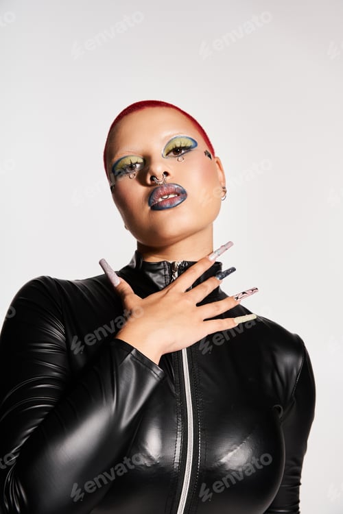 Preview: Boldly expressing unique style, a young woman poses in a studio with vibrant pink hair
