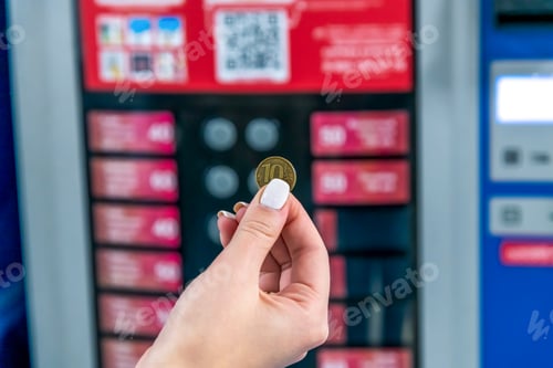 Preview: Woman holds 10 rouble coin by vending machine