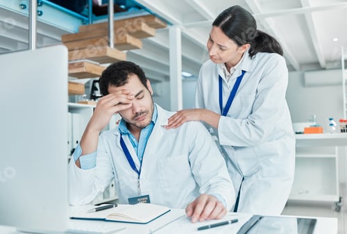 Preview: Shot of a young scientist looking stressed out while being consoled by a colleague in a lab