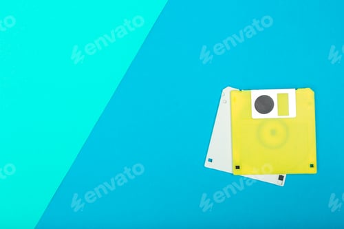 Preview: Bright colored floppy disks on a blue background illustrating vintage tech items from the past