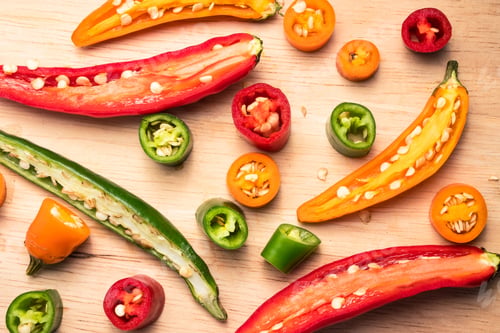 Preview: Colorful mix of chili pappers on wooden background.
