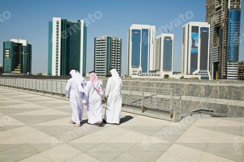 Preview: Group of individuals in traditional attire against a backdrop of modern skyscrapers