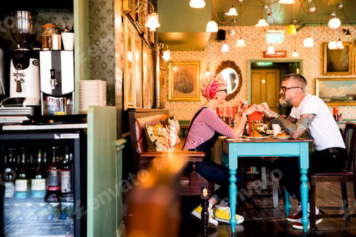 Preview: Quirky couple relaxing in bar and restaurant, Bournemouth, England