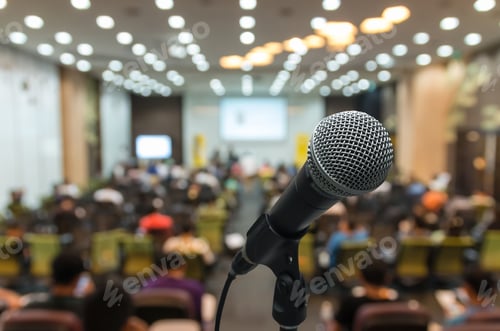 Preview: Microphone over the Abstract blurred photo of conference hall or seminar room