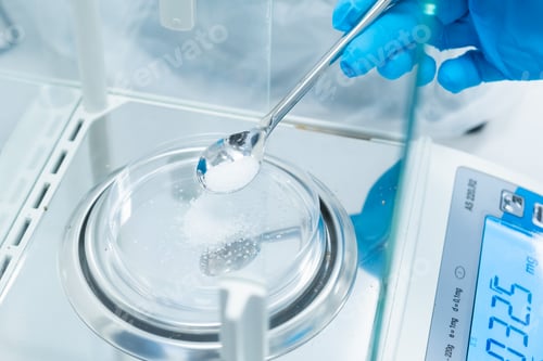 Preview: Close up scientist hands in rubber gloves use metal spatula for weighing white powder