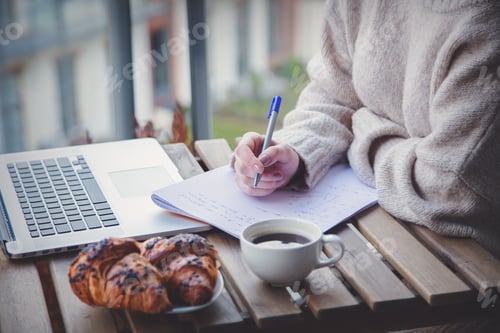 Preview: Beautiful young businesswoman working on laptop