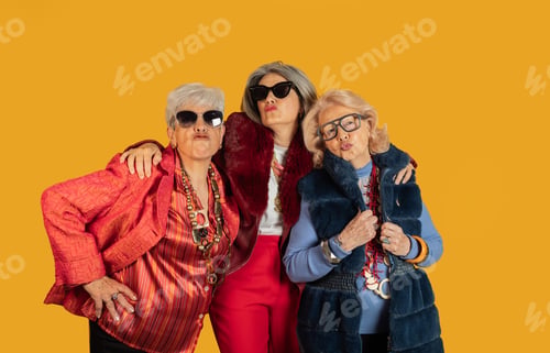 Preview: Three fashionable senior women embracing stylish confidence on yellow background